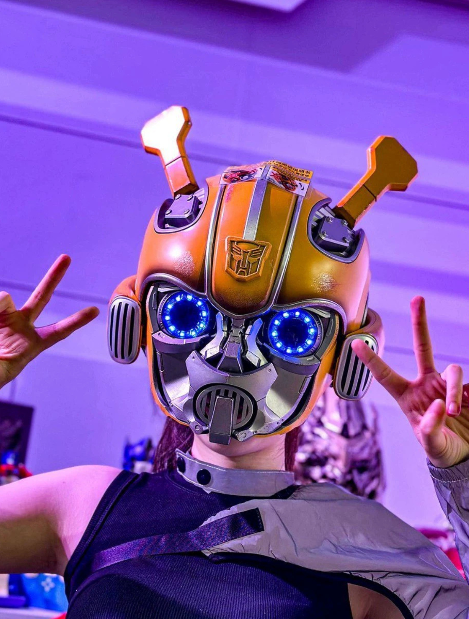 Person wearing the Bumblebee helmet at a convention, blue LED eyes on