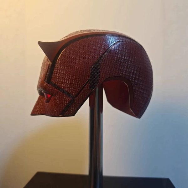 Side view of the red Daredevil Born Again mask on a display stand